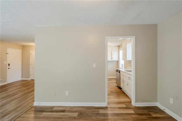 270 Hunt Ridge Dr, Stockbridge, GA 30281 - spare room featuring light wood-style flooring, baseboards, and a textured ceiling