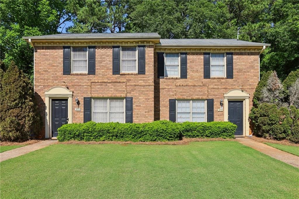 373 Dixie Ct, Lawrenceville, GA 30046 - view of front facade featuring a front yard and brick siding