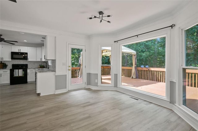 2316 Fripp Overlook NW, Acworth, GA 30101 - unfurnished living room with light wood-style floors, crown molding, and ceiling fan