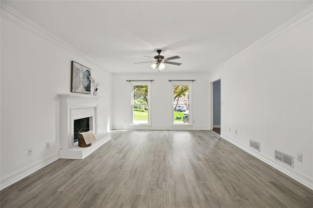 2316 Fripp Overlook NW, Acworth, GA 30101 - unfurnished living room with ceiling fan, ornamental molding, wood finished floors, and a brick fireplace