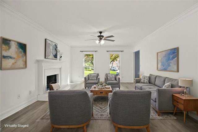 2316 Fripp Overlook NW, Acworth, GA 30101 - living area with crown molding, a ceiling fan, wood finished floors, and a fireplace with raised hearth