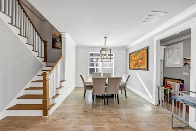 bedroom featuring hardwood / wood-style flooring, ceiling fan, and crown molding