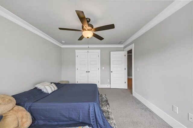 carpeted bedroom featuring ornamental molding and ceiling fan