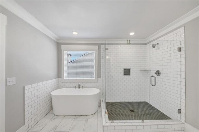 bathroom with vanity, crown molding, and plus walk in shower