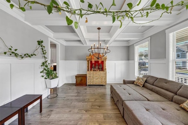 interior space featuring beam ceiling, hardwood / wood-style flooring, coffered ceiling, and an inviting chandelier