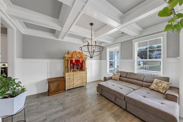 living room featuring coffered ceiling, hardwood / wood-style floors, beam ceiling, and a notable chandelier