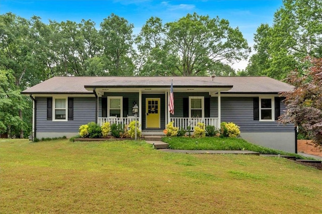 ranch-style home featuring a porch and a front lawn