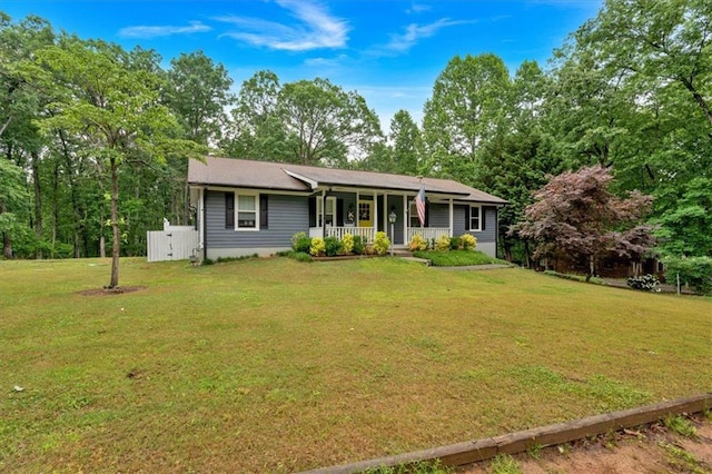 ranch-style home with covered porch and a front lawn