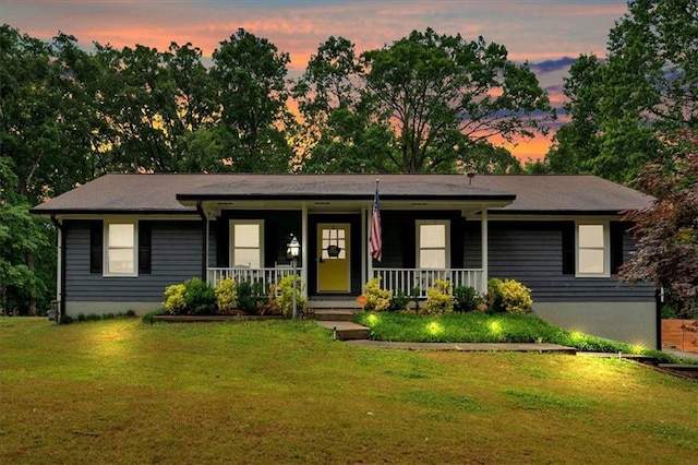 ranch-style home featuring a yard and a porch