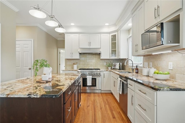 2802 Arabian Trl NE, Marietta, GA 30062 - kitchen with stainless steel appliances, under cabinet range hood, a sink, white cabinetry, and light wood-style floors