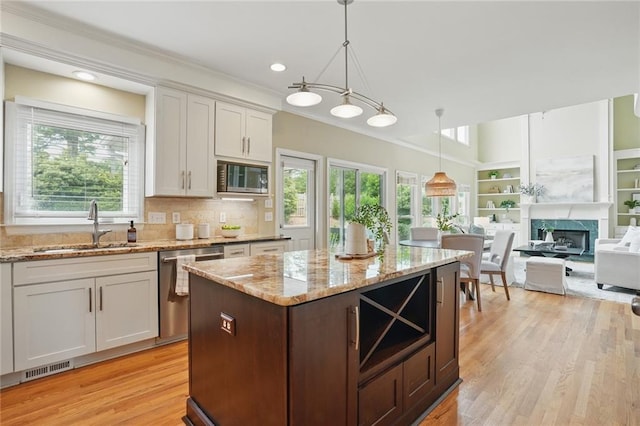 2802 Arabian Trl NE, Marietta, GA 30062 - kitchen with a sink, appliances with stainless steel finishes, healthy amount of natural light, light wood-type flooring, and crown molding