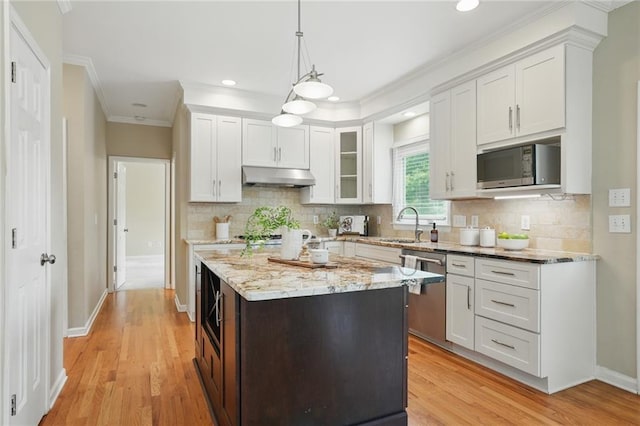 2802 Arabian Trl NE, Marietta, GA 30062 - kitchen with appliances with stainless steel finishes, under cabinet range hood, ornamental molding, white cabinets, and glass insert cabinets