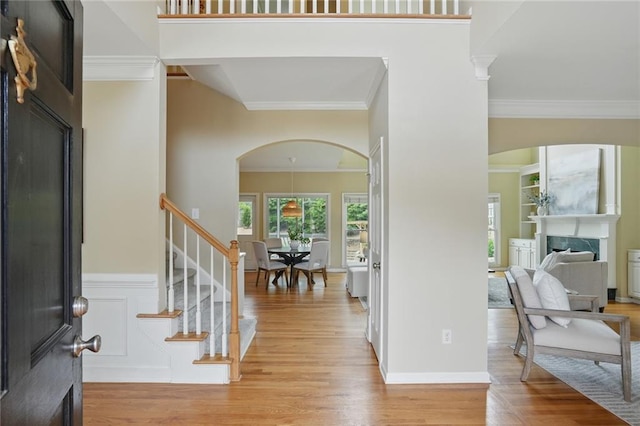 2802 Arabian Trl NE, Marietta, GA 30062 - entrance foyer with arched walkways, crown molding, wood finished floors, a premium fireplace, and stairs
