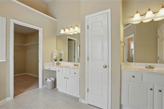 2802 Arabian Trl NE, Marietta, GA 30062 - bathroom featuring tile patterned flooring, two vanities, baseboards, and a walk in closet