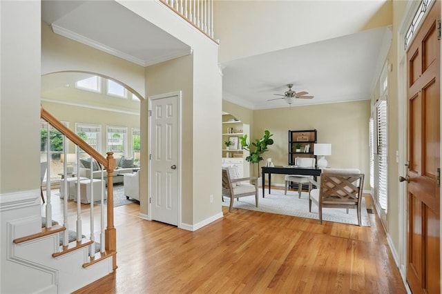 2802 Arabian Trl NE, Marietta, GA 30062 - foyer entrance featuring crown molding, ceiling fan, light wood-style flooring, baseboards, and stairs