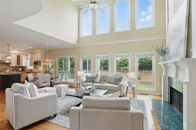 2802 Arabian Trl NE, Marietta, GA 30062 - living area featuring a ceiling fan, a fireplace, light wood-style floors, a towering ceiling, and recessed lighting