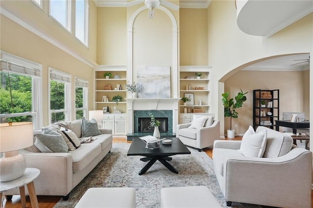 2802 Arabian Trl NE, Marietta, GA 30062 - living room featuring a ceiling fan, a high ceiling, ornamental molding, arched walkways, and wood finished floors