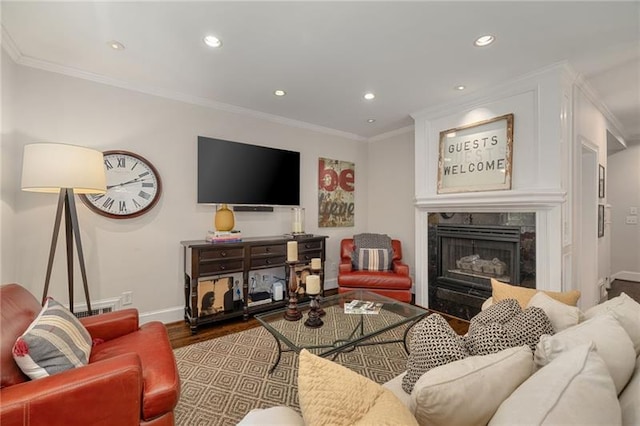 living area featuring wood finished floors, recessed lighting, crown molding, a premium fireplace, and baseboards