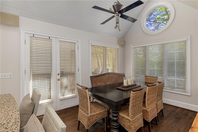 dining area featuring dark wood finished floors, lofted ceiling, a ceiling fan, and baseboards