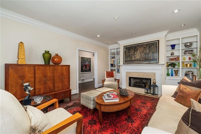 living room with a high end fireplace, built in features, recessed lighting, and ornamental molding