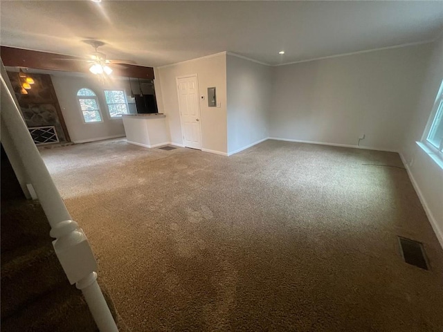 unfurnished living room featuring visible vents, baseboards, light colored carpet, and ornamental molding