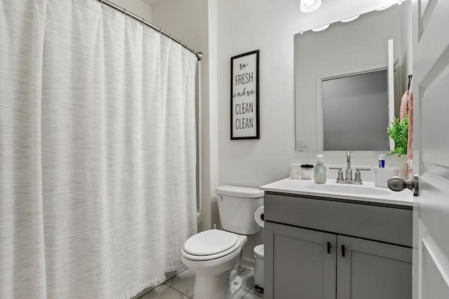 bathroom featuring vanity, tile patterned floors, and toilet