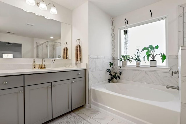 bathroom featuring vanity, shower with separate bathtub, and tile walls