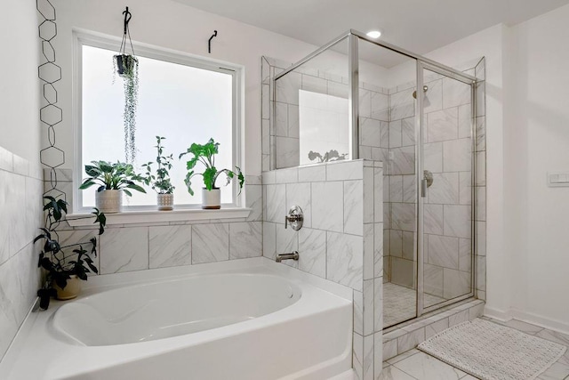 bathroom with a healthy amount of sunlight and plus walk in shower