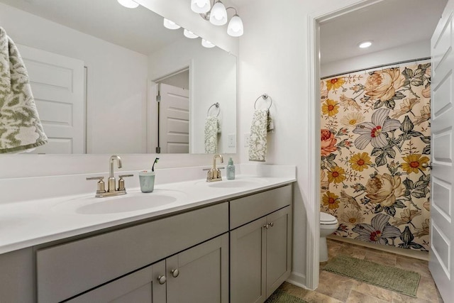 bathroom featuring walk in shower, vanity, and toilet