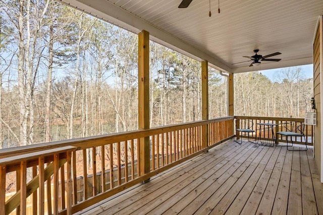 wooden deck featuring ceiling fan