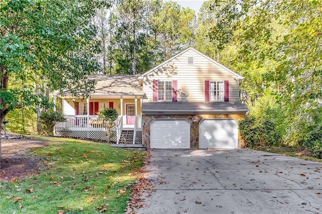 view of front of home with covered porch, a front lawn, and a garage