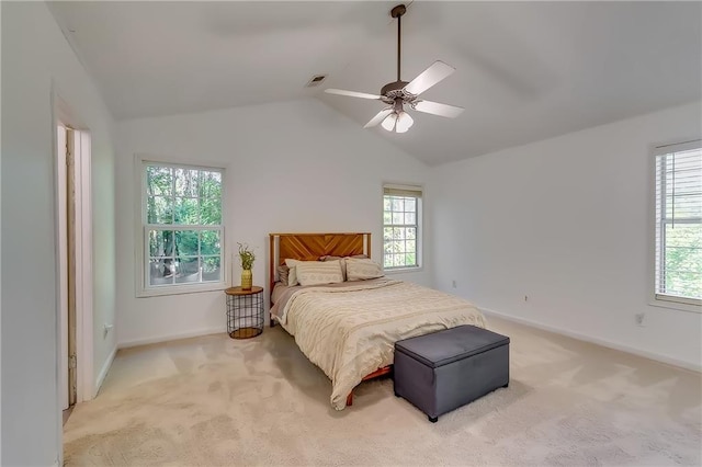 bedroom featuring ceiling fan, light carpet, and vaulted ceiling