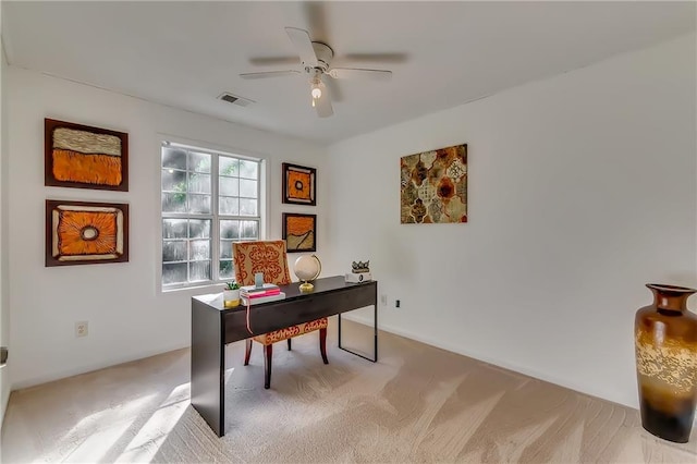 home office with light carpet and ceiling fan