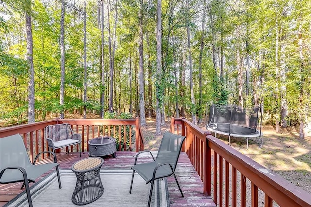 wooden deck featuring a trampoline