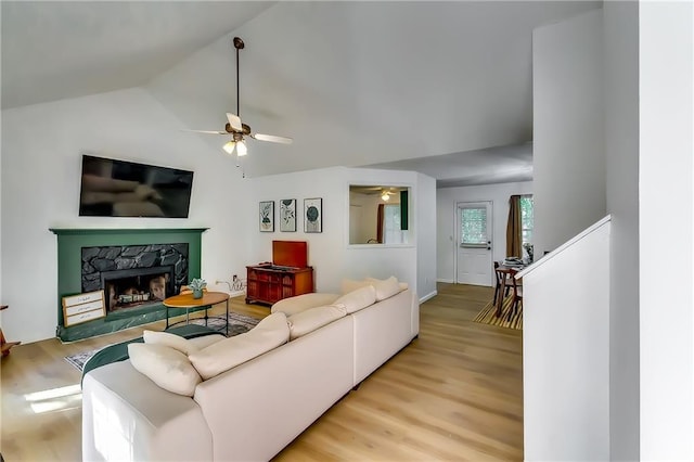 living room with lofted ceiling, light wood-type flooring, and ceiling fan