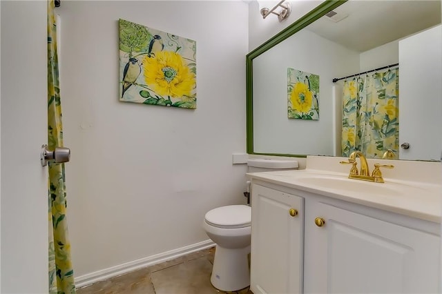 bathroom featuring vanity, toilet, and tile patterned floors