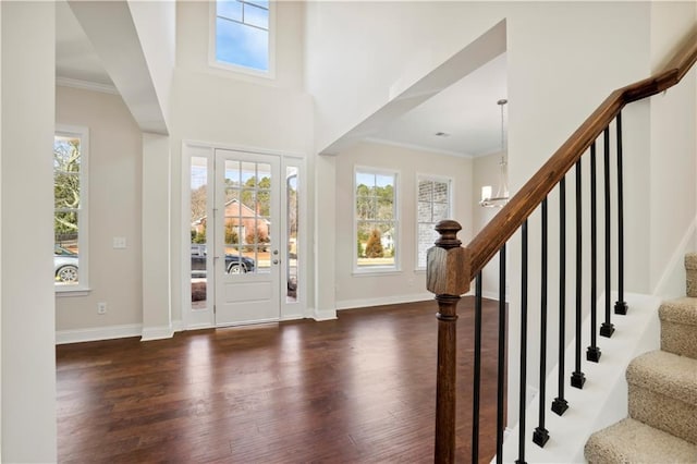 5997 Creek Indian Dr, Sugar Hill, GA 30518 - entrance foyer with dark wood finished floors, plenty of natural light, a chandelier, and crown molding
