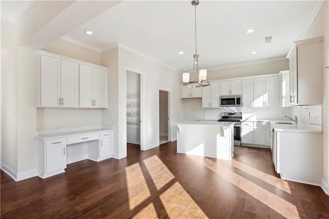 5997 Creek Indian Dr, Sugar Hill, GA 30518 - kitchen with appliances with stainless steel finishes, built in desk, dark wood-style flooring, a center island, and recessed lighting