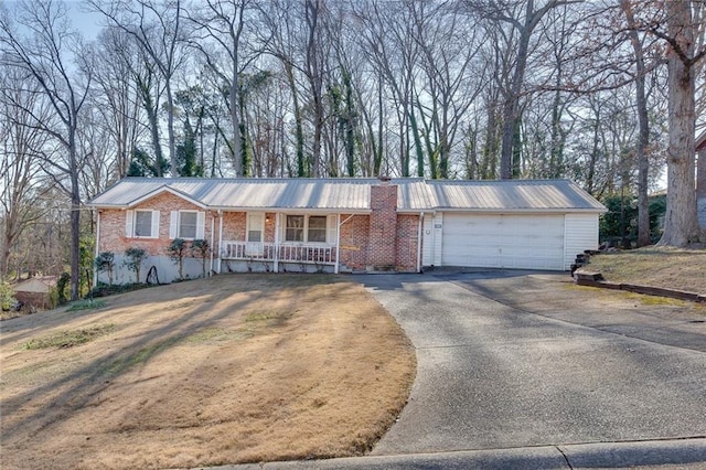 single story home featuring a porch and a garage