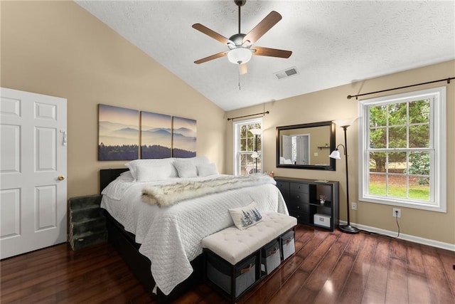 bedroom featuring visible vents, a textured ceiling, wood finished floors, and vaulted ceiling