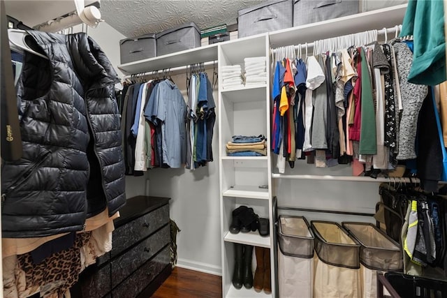 walk in closet with wood finished floors