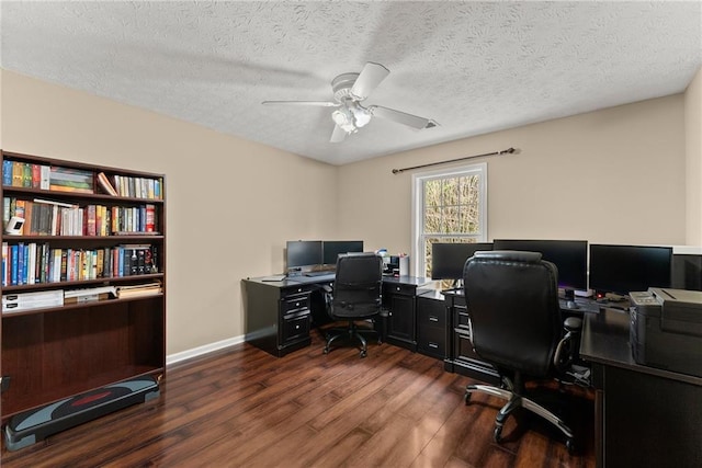 office area with baseboards, a textured ceiling, ceiling fan, and dark wood finished floors