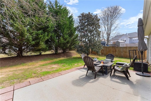 view of patio / terrace with fence and an outdoor fire pit