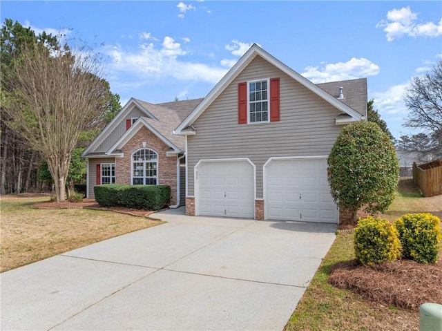 traditional home featuring fence, concrete driveway, a front yard, a shingled roof, and a garage