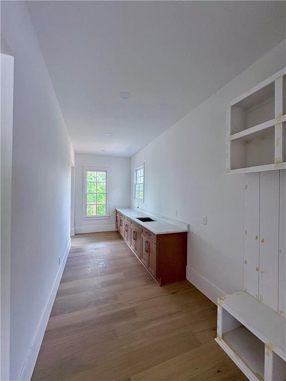mudroom featuring light wood-style flooring and baseboards