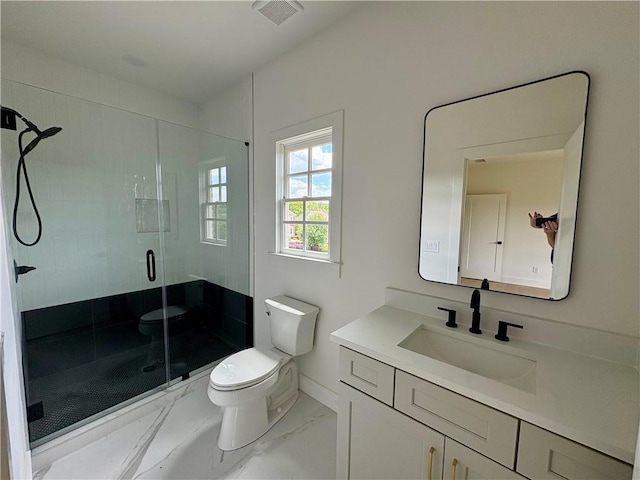 full bath featuring marble look tile flooring, toilet, a shower stall, vanity, and baseboards