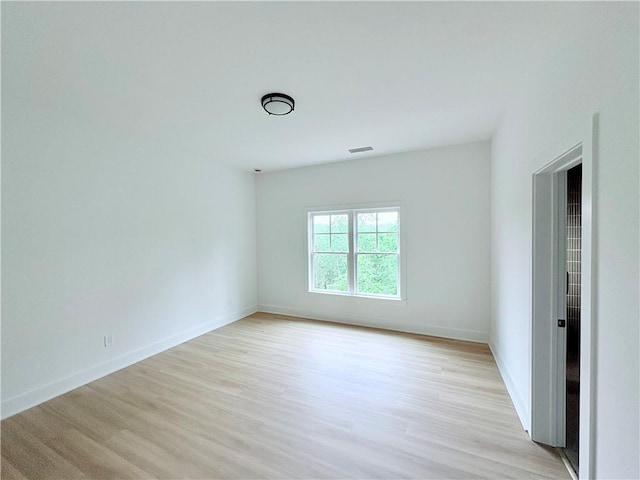 unfurnished room featuring light wood finished floors and baseboards
