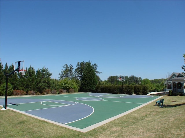view of basketball court with community basketball court and a lawn