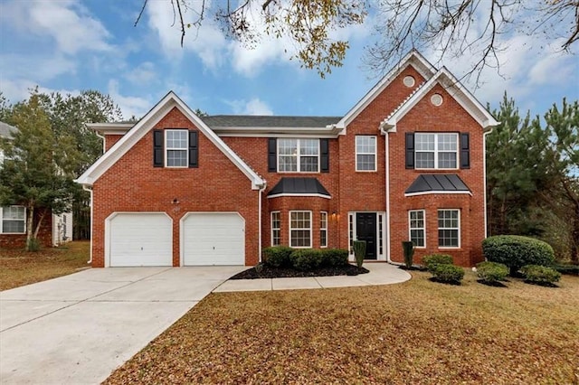 view of front of home with a garage and a front yard