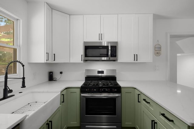 3142 Chamblee Gap Rd, Cumming, GA 30040 - kitchen with appliances with stainless steel finishes, green cabinetry, a sink, and white cabinetry